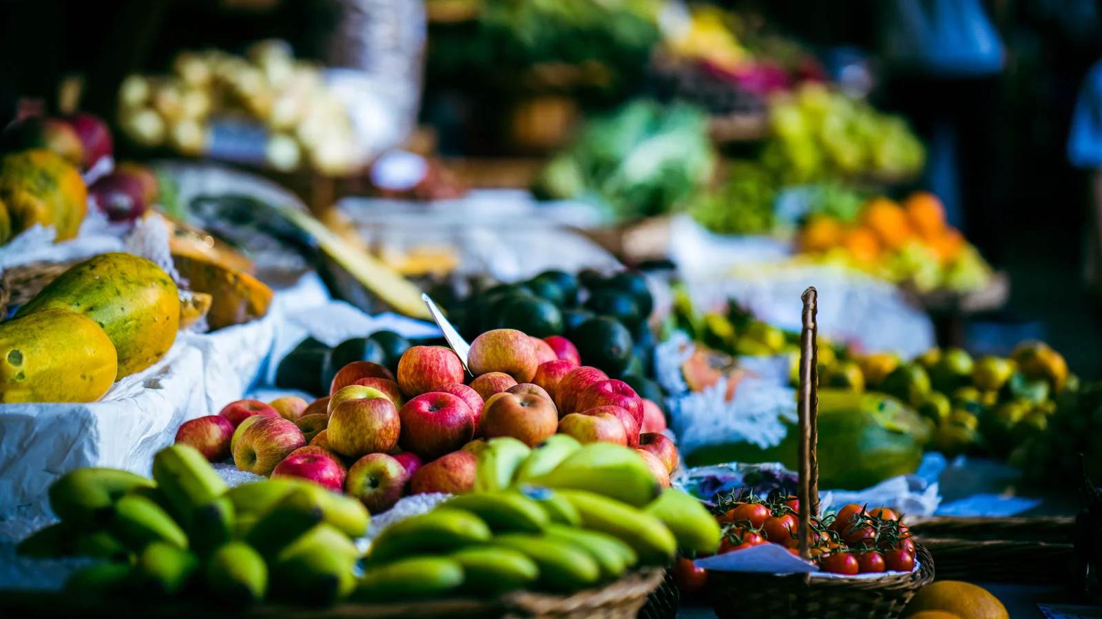Baskets of fresh fruit on a bright market stall, the kind of produce customs officers stop at the border