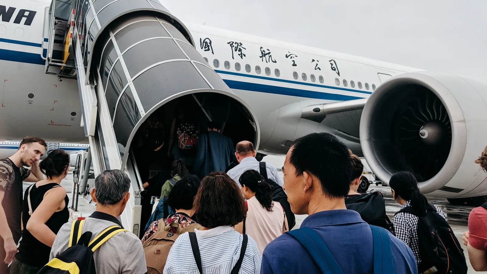 Passengers boarding an aircraft through a jet bridge