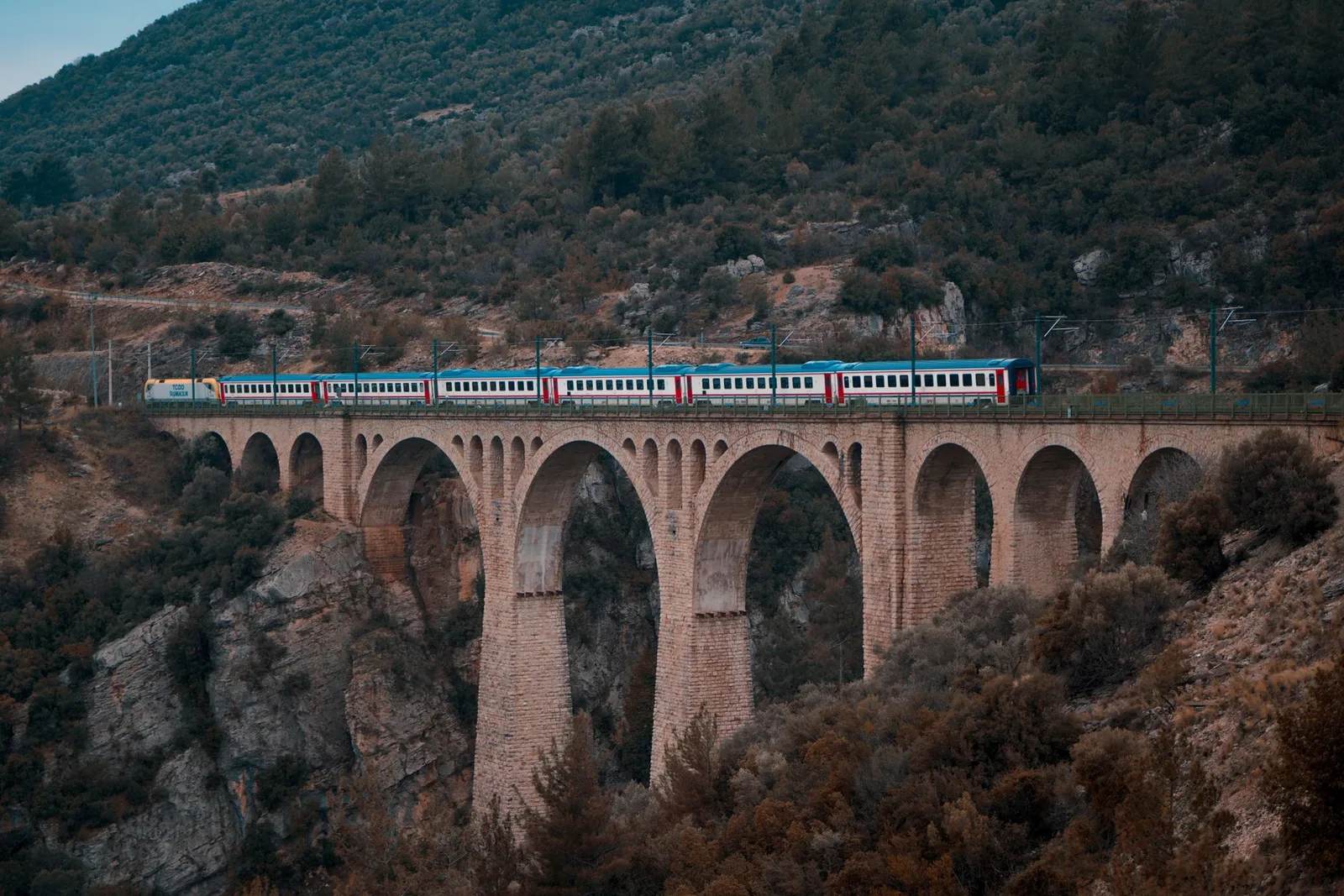 Passenger train railway viaduct mountain scenery — illustrating The World's 12 Most Spectacular Train Journeys for