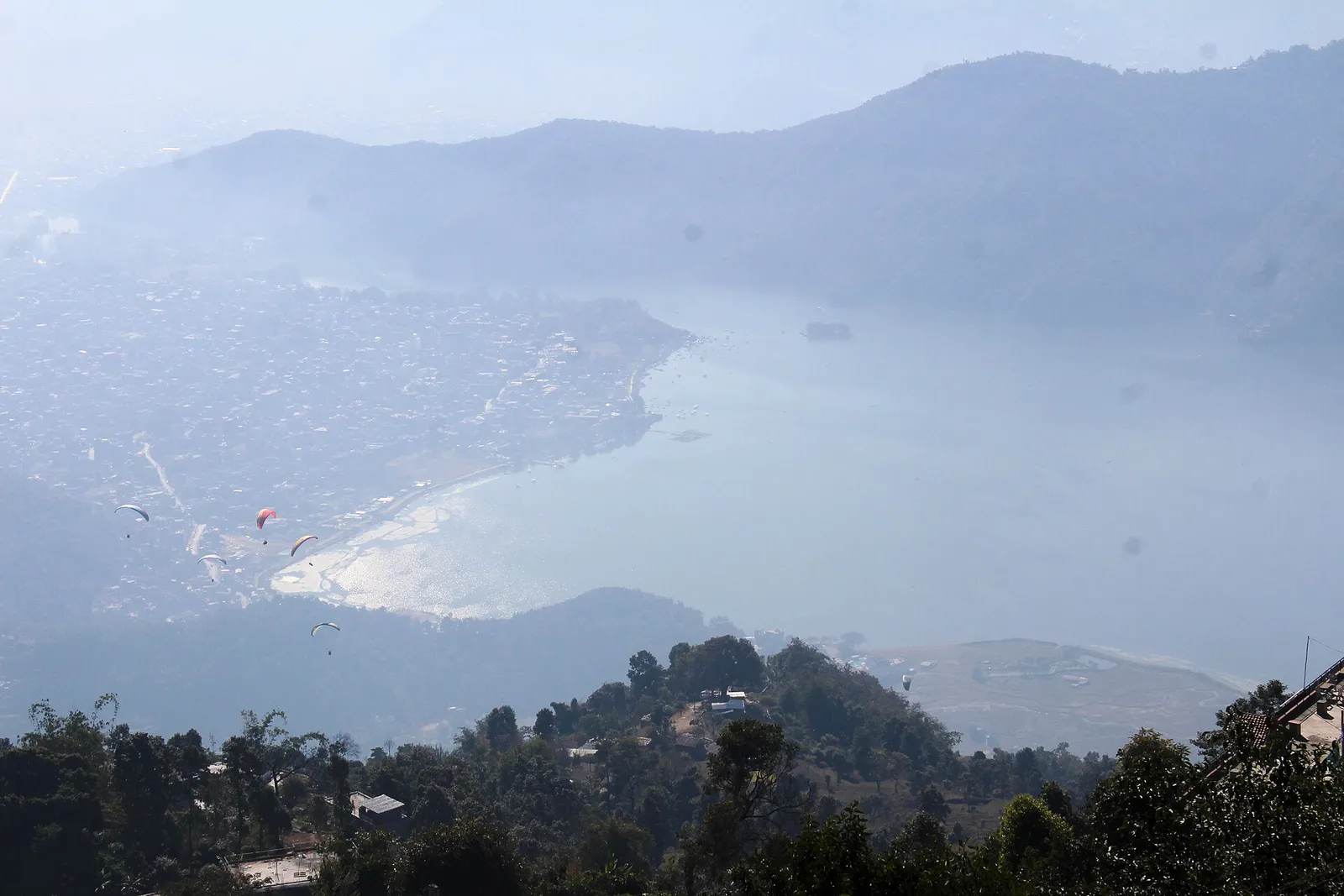 Tandem paraglider over Phewa Lake Pokhara with Annapurna mountains