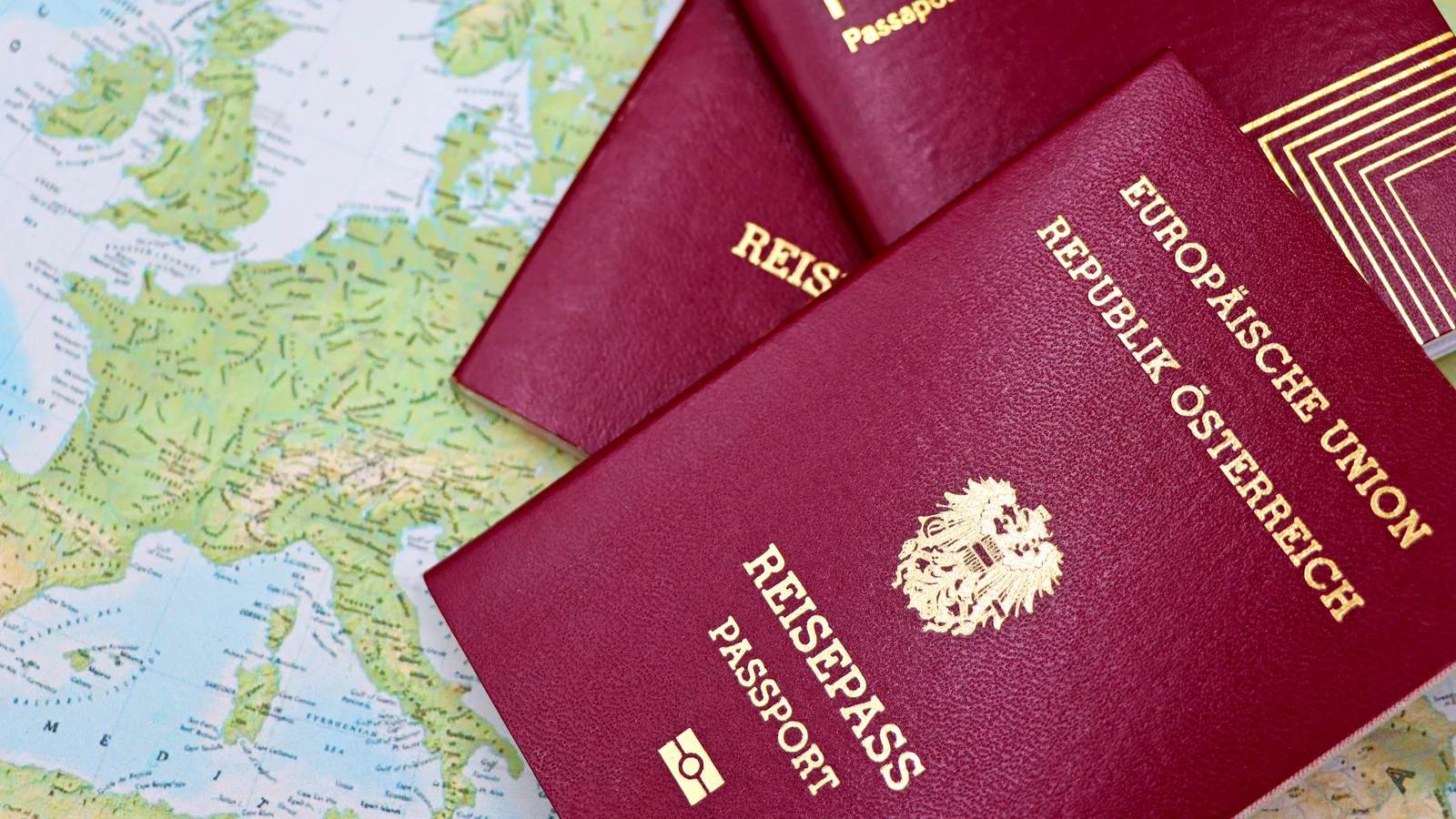 Two passports lying on a world map