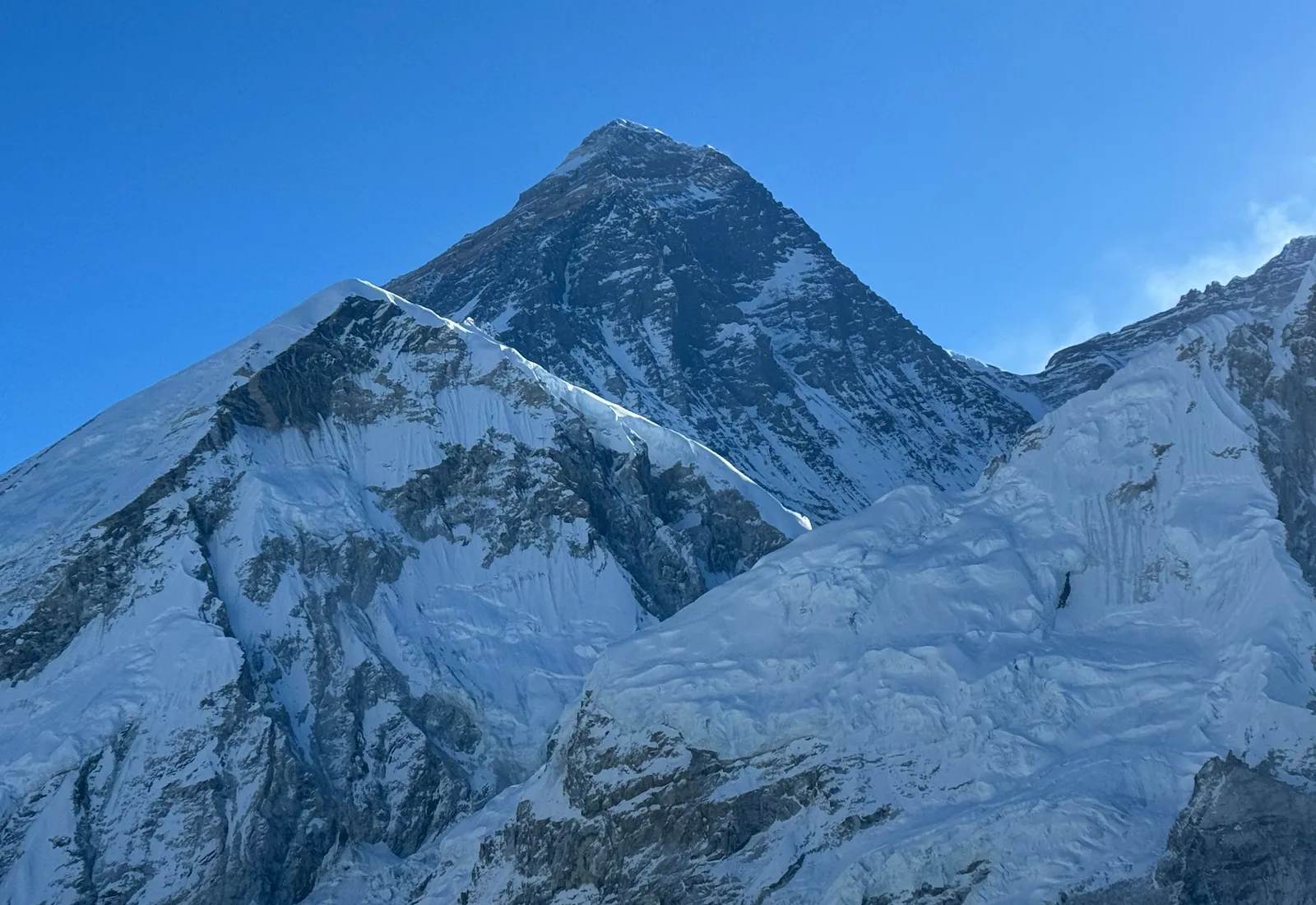 The summit pyramid of Everest under a clear blue sky