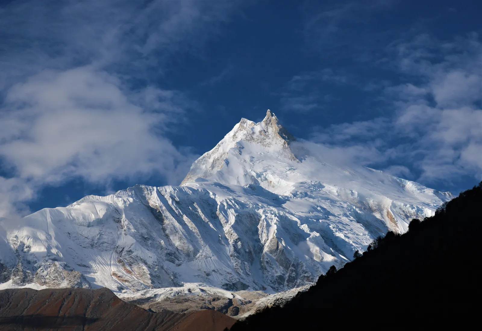 Snow-covered Manaslu under a clear blue sky