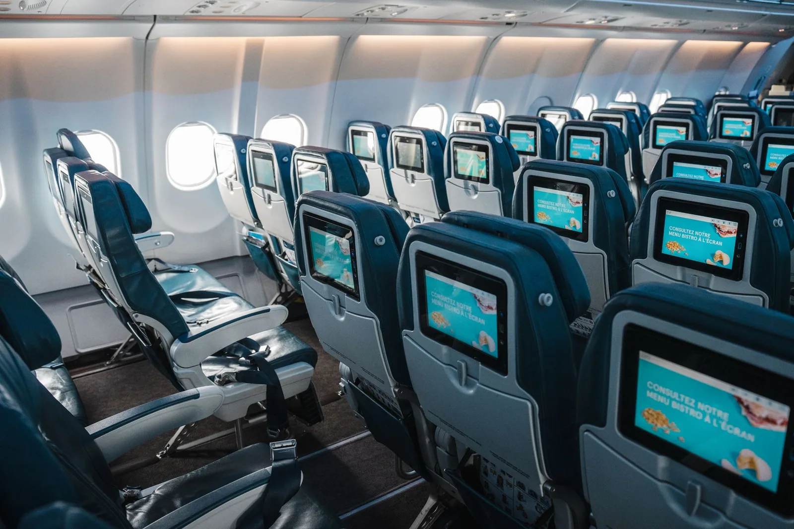 Rows of economy-class seats inside a passenger aircraft cabin