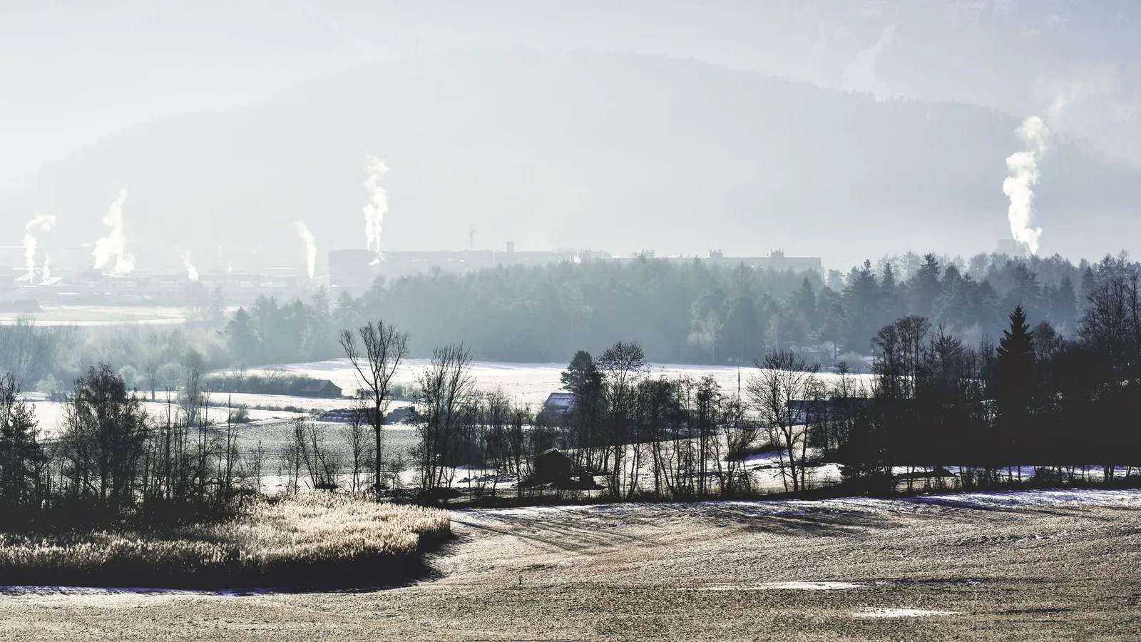 A thick haze of air pollution hanging over hills and Himalayan peaks in South Asia, dulling the light and greying the snow