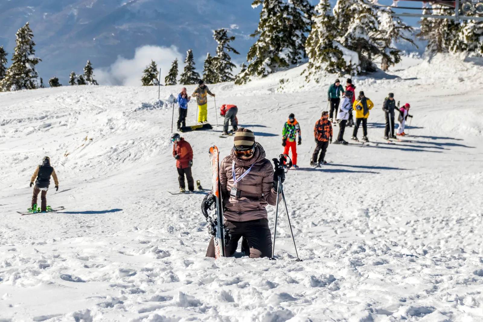 Skiers on a snow-covered mountain slope at a ski resort — Eastern Europe and the Pyrenees offer Alpine-style skiing at a fraction of marquee-resort prices