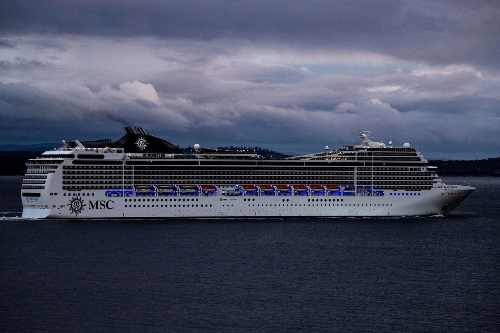 A large cruise ship sailing on the open ocean at sea — where onboard medical care is limited and reaching a hospital can mean an at-sea evacuation