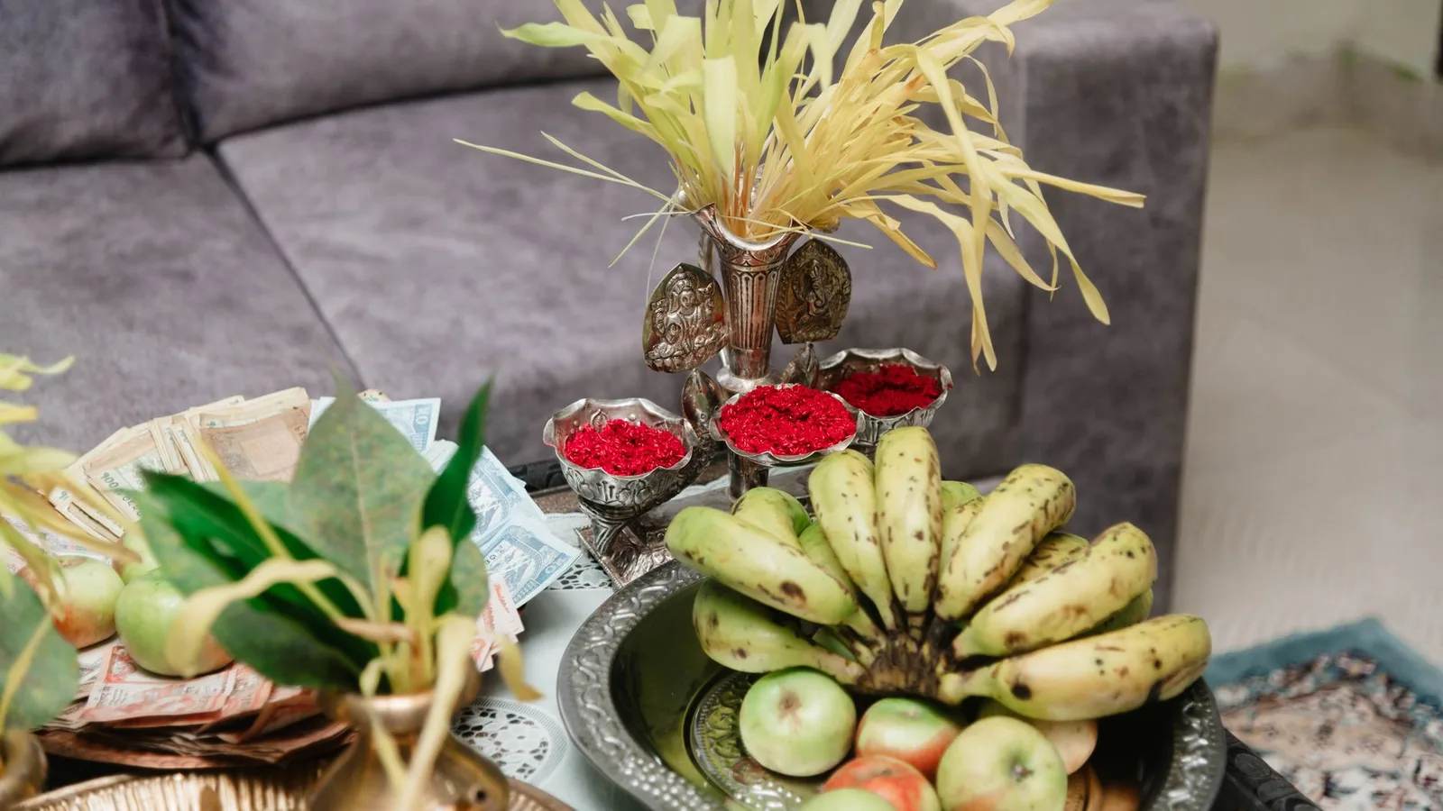 A Dashain tray with jamara shoots, red tika powder, bananas and offerings