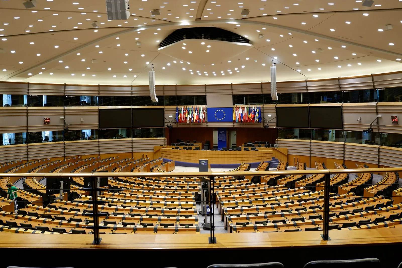 The debating chamber of the European Parliament in Brussels, ringed by EU member-state flags and the European Union emblem — visa-exempt visitors will soon need an ETIAS authorisation to enter the Schengen area