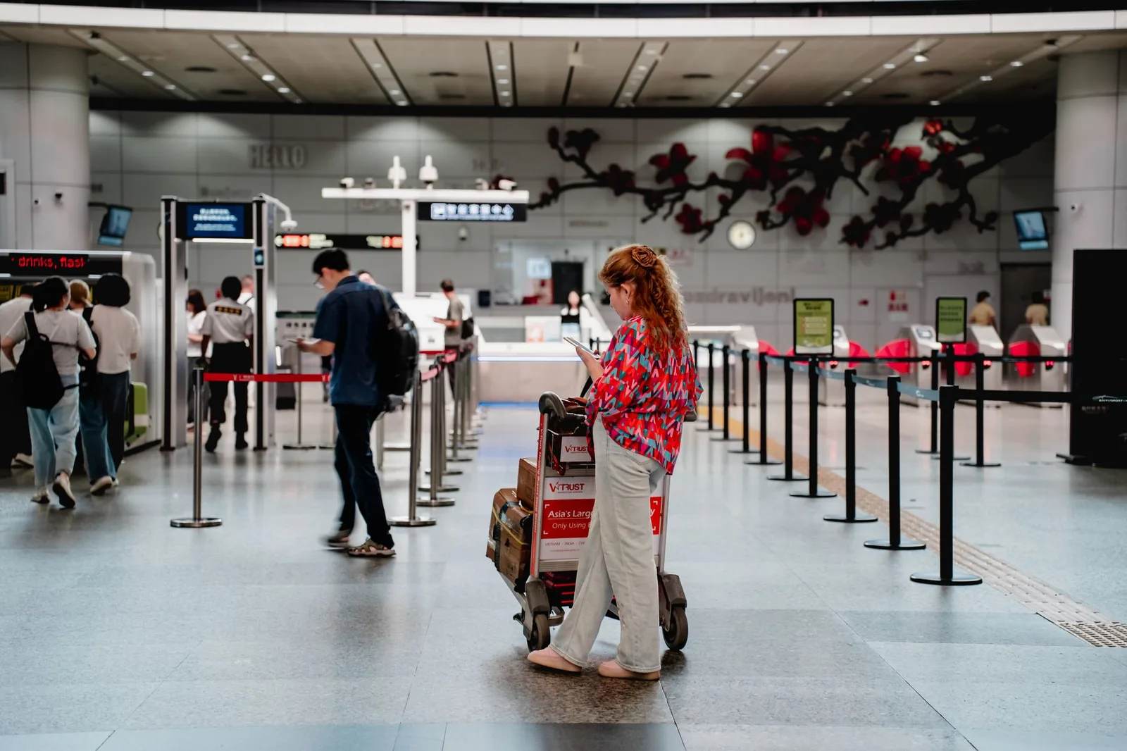 Travellers with luggage at an airport check-in counter
