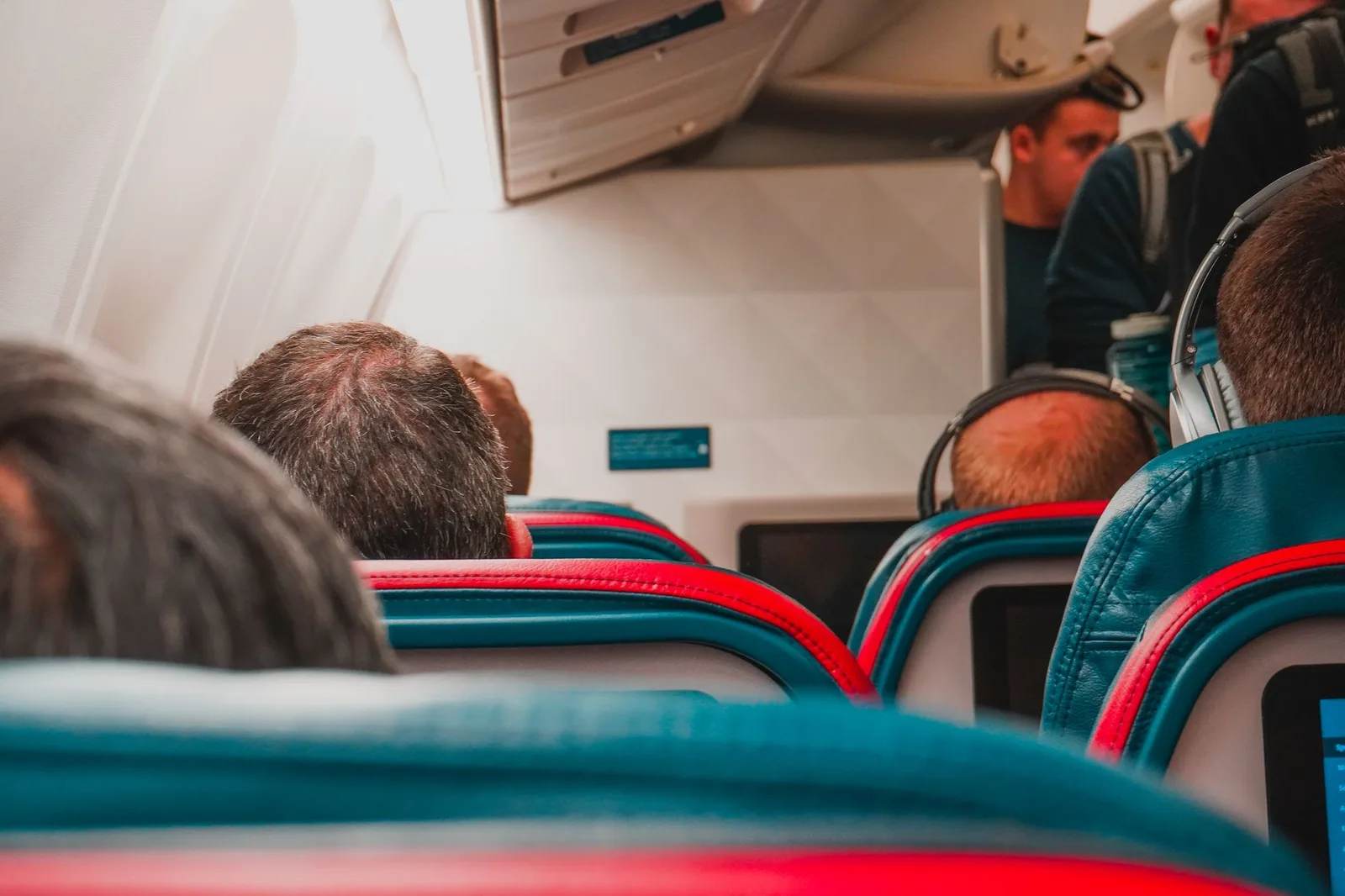 Wide, spacious premium-economy seats with extra legroom and footrests inside a passenger aircraft cabin