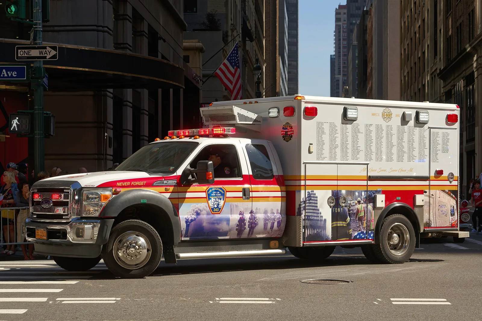 A New York City ambulance on a Manhattan street — emergency medical care in the USA can cost visiting travellers tens of thousands of dollars, 2026.