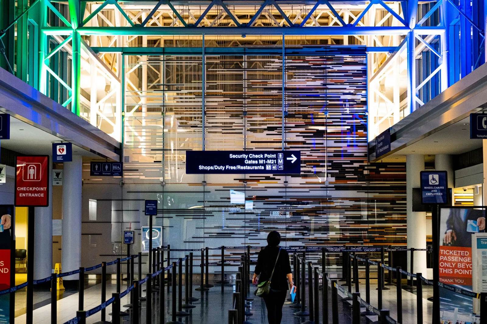 Travellers waiting in line at an airport security screening checkpoint, the queue that trusted-traveller programs like TSA PreCheck are designed to shorten