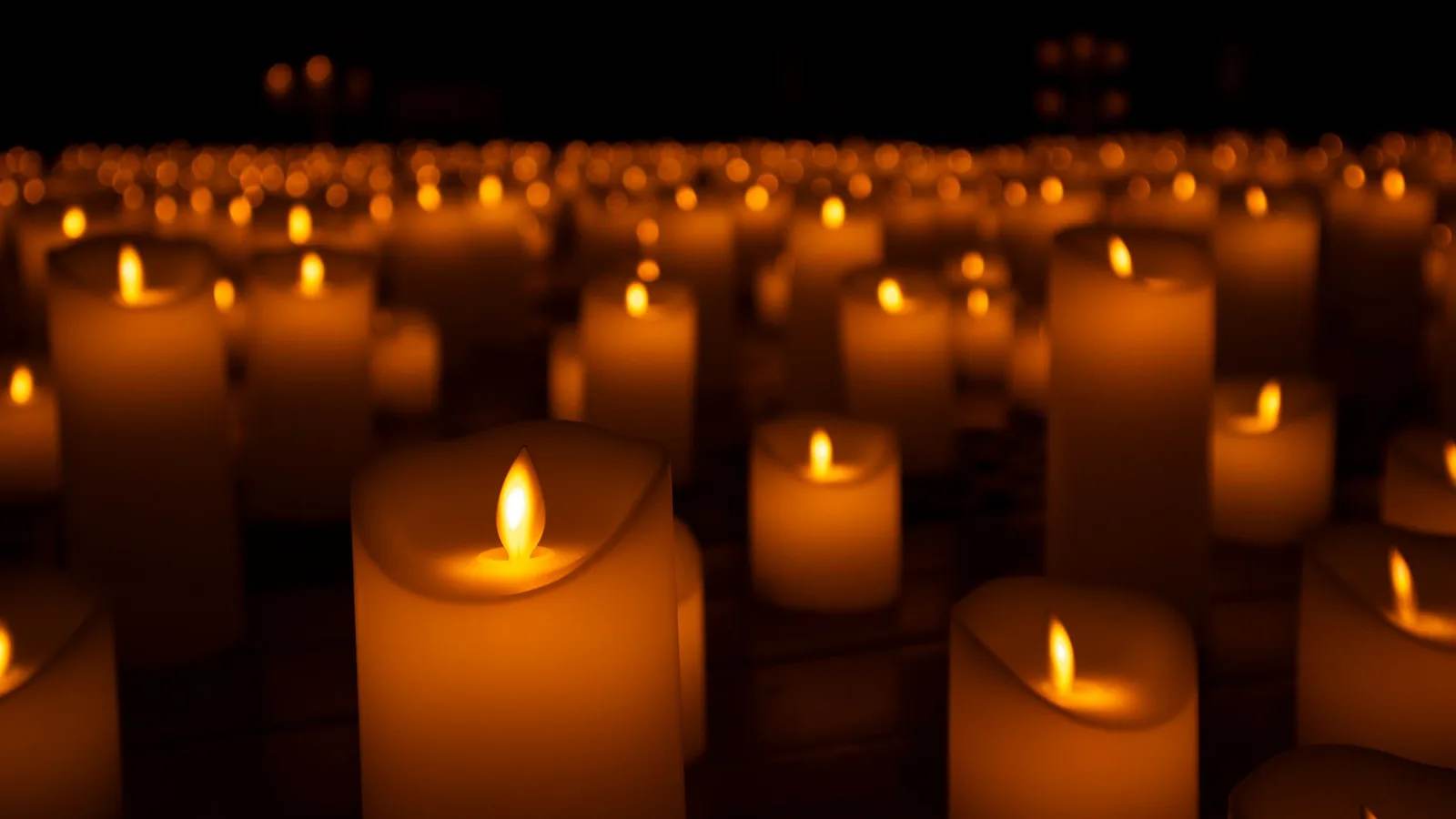 File photo: lit candles at a memorial vigil — an illustrative image of the condolences offered to Nepal by world and faith leaders after the 2026 floods; not from a specific ceremony