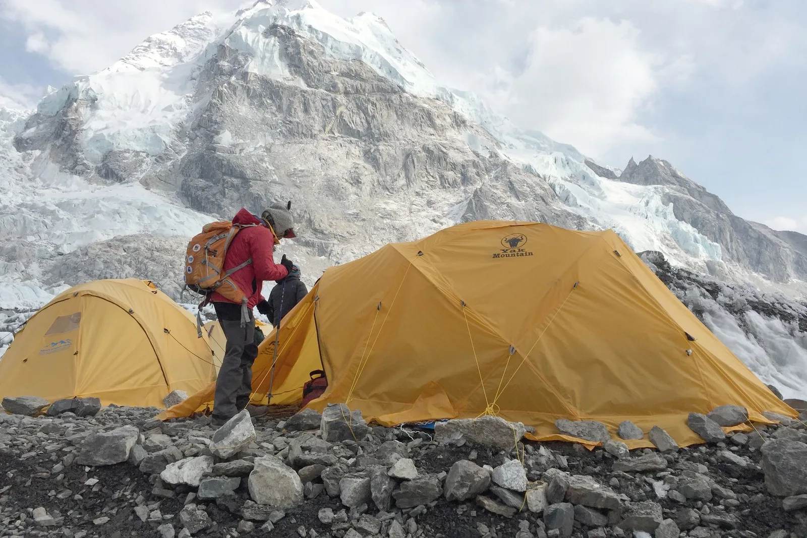 Trekkers on the Everest Base Camp trail in Nepal with Himalayan peaks behind — the classic trek for US travelers in 2026