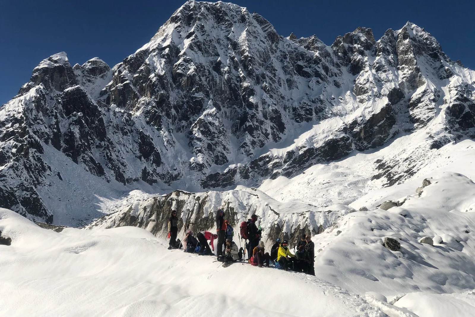 A mountaineer high on a snow-covered Himalayan ridge in the Everest region, illustrating the extreme high-altitude terrain that makes Everest deadly