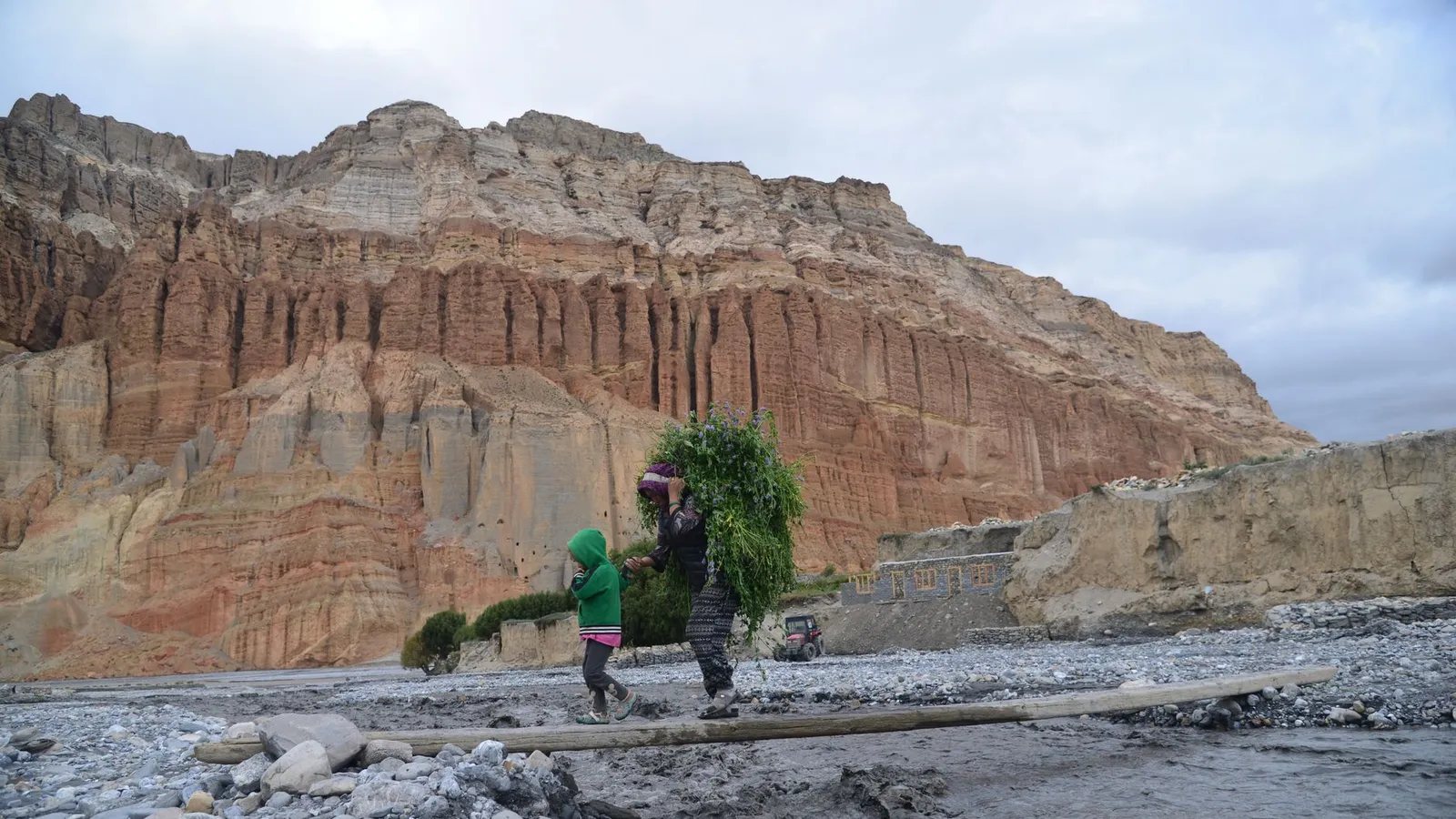 Family hiking together on an easy Himalayan trail in Nepal