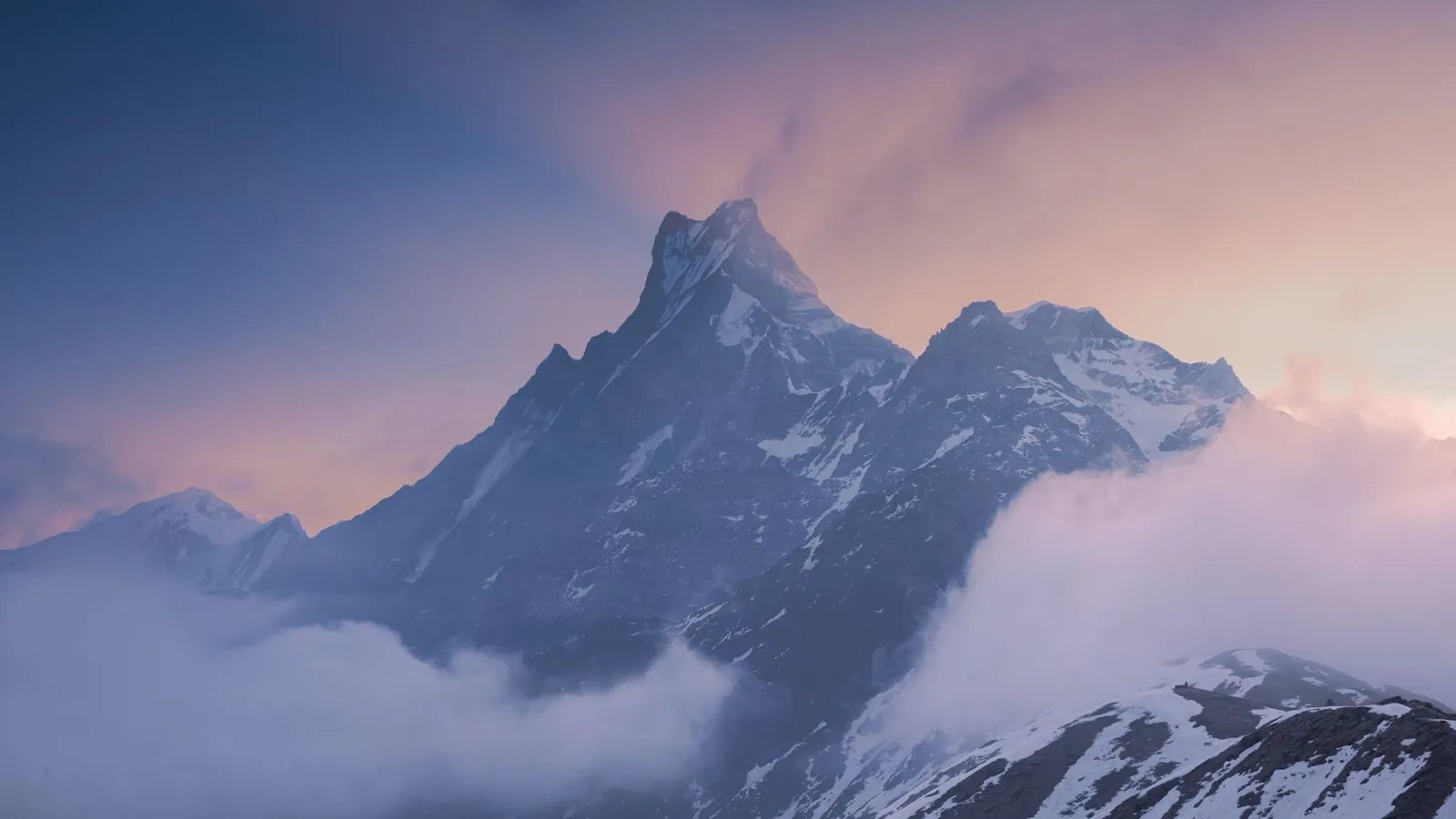 Climbers ascending a snow-capped Himalayan peak in Nepal